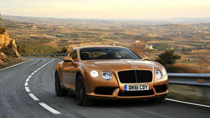 Sweeping Design - Bentley Continental Gt On The Road Wallpaper