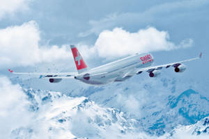 Swiss Airlines Airplane On A Cloudy Mountain Wallpaper