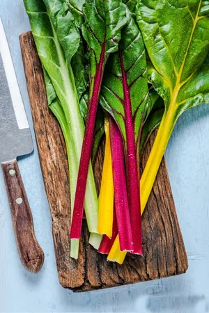 Swiss Chard Vegetable On Old Wooden Chopping Board Wallpaper
