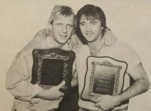 Tag Team Champions Holding Plaques Wallpaper