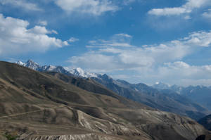 Tajikistan Rock Formation And Clouds Wallpaper