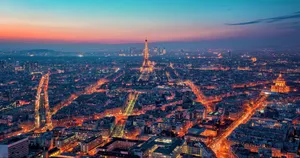 Take In The Evening City Lights Of Paris From A Rooftop View Wallpaper