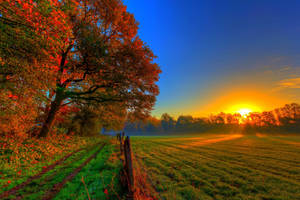 Take In The Gorgeous Colors Of A Sunset Fall Farm. Wallpaper