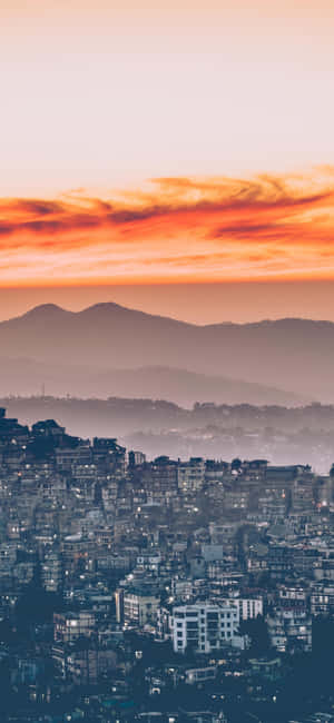 Take In The View Of A Beautiful City Sunset With Your Iphone. Wallpaper