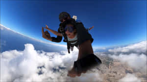 Tandem Skydiving Above Clouds Wallpaper