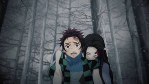 Tanjiro Carrying Nezuko In Demon Slayer Wallpaper