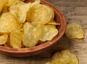Tantalizing Crispy Potato Chips In A Ceramic Bowl Wallpaper