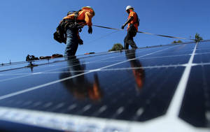 Technician Installing Solar Panels Wallpaper