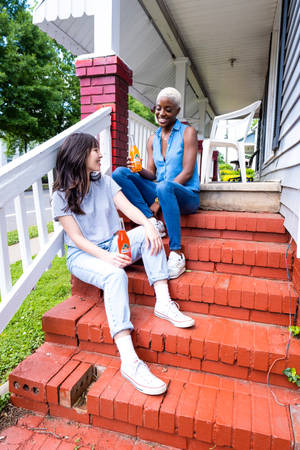 Teenage Girlfriends Outside House Wallpaper