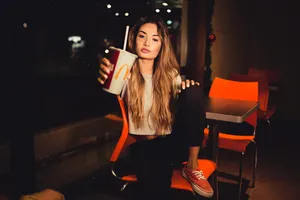 Teenager Holding Mcdonald's Cup Wallpaper