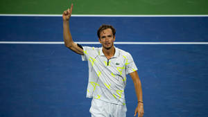 Tennis Pro Daniil Medvedev Pointing Skywards Wallpaper