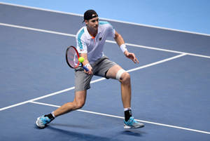 Tennis Pro John Isner Showcasing His Skills Wallpaper