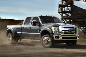 The 2014 Ford F-350 F-450 Is Driving On A Dirt Road Wallpaper