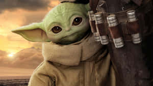 The Baby Yoda Is Holding A Gun Wallpaper