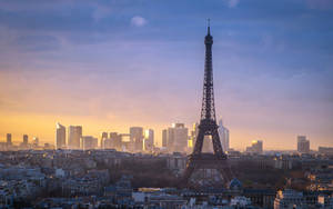 The Beauty Of Paris: A Romantic Sunset View Of The Eiffel Tower Wallpaper