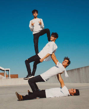 The Dobre Brothers Posing In Stylish White Tees Wallpaper