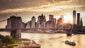 The Dramatic Sunset Over The Iconic Brooklyn Bridge In New York City. Wallpaper