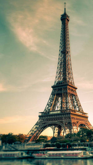 The Eiffel Tower Stands Tall Against The Skyline Of Paris, A Symbol Of French History And Culture. Wallpaper