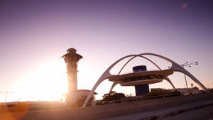 The Famous Los Angeles Theme Building At Lax, Illuminated By The Morning Sun Wallpaper