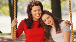 The Gilmore Girls Enjoying A Peaceful Moment In The Park Swing Wallpaper