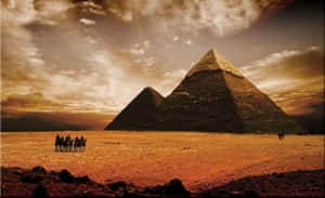 The Majestic Giza Pyramids Under Sunny Egyptian Skies Wallpaper
