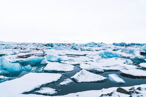 The Marble-like Ice Of Iceland Wraps Snow White In A Comforting Embrace Wallpaper