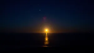 The Moon Is Rising Over The Ocean Wallpaper