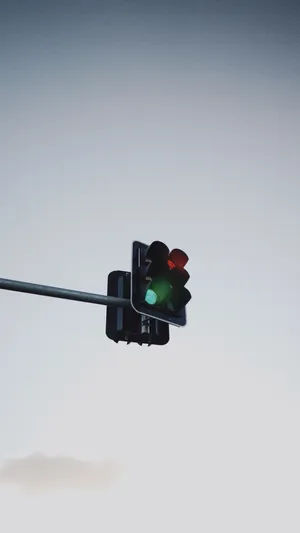 The Perfect Green Hues Of A Traffic Light Against A Bright Blue Sky Wallpaper