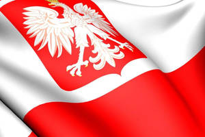 The Proud Polish Flag Fluttering In The Wind Against A Clear Blue Sky. Wallpaper
