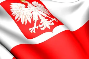 The Proud Polish Flag Fluttering In The Wind Against A Clear Blue Sky. Wallpaper