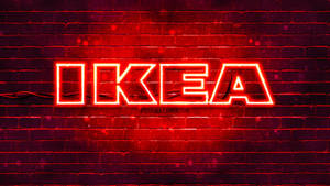 The Renowned Ikea Logo In Vibrant Red Led Signage Against A Unique Brick Accent Wall. Wallpaper