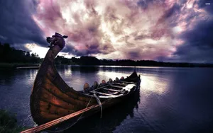 The Sight Of A Lone Viking Ship Sailing Off Into The Sunset. Wallpaper