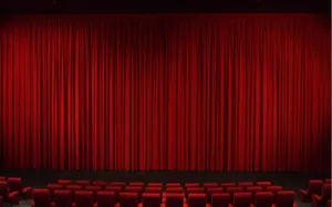 Theater With Long Red Curtains Wallpaper