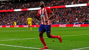 Thomas Partey Running Across A Green Field Wallpaper