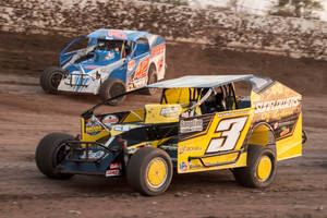 Three Dirt Track Racing Cars On A Dirt Track Wallpaper