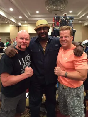 Three Men Posingat Event Wallpaper