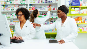 Three Pharmacists Helping Each Other Wallpaper