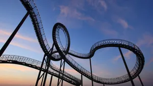 Thrilling Roller Coaster Illuminated At Night Wallpaper