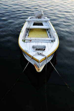 Tied Boat On Dark Water Wallpaper