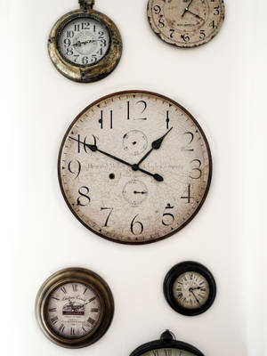 Timeless Elegance - A Trio Of Antique Clocks Wallpaper