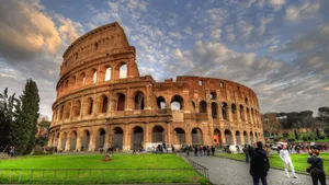 Tourists Taking Pictures Outside The Colosseum Wallpaper