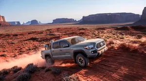 Toyota Trd Driving Fast In The Desert Wallpaper