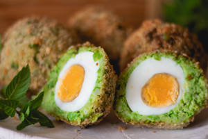 Traditional British Scotch Eggs Dish With Avocado Wallpaper