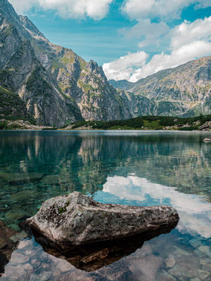 Translucent Lake With Massive Rock Wallpaper