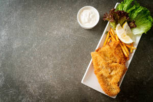 Tray Of Fish And Chips On A Counter Wallpaper