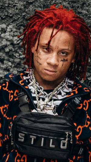 Trippie Redd Striking A Passionate Stage Performance Wallpaper