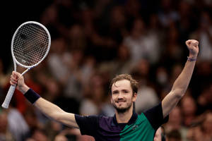 Triumph Moment - Daniil Medvedev Raising His Hands In A Match Wallpaper