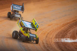 Two Dirt Track Racing Cars On A Dirt Track Wallpaper