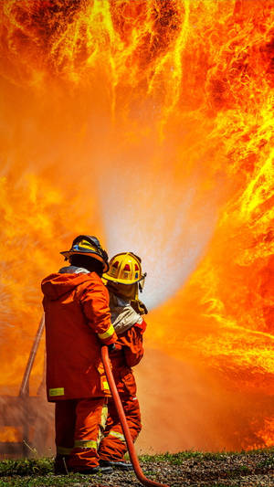 Two Firefighters In Front Of Large Fire Wallpaper