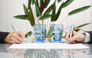 Two Hands Signing A Contract Wallpaper